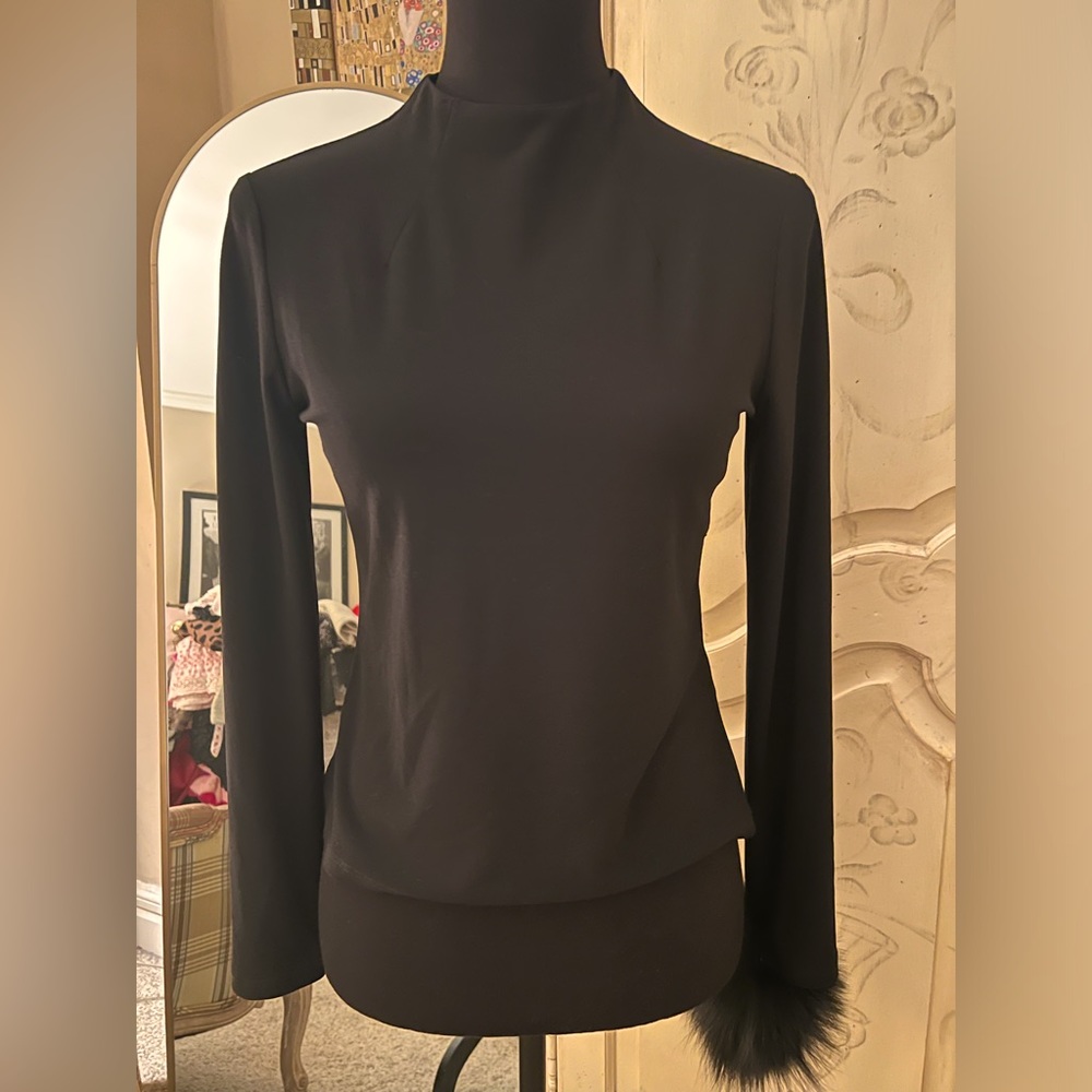 Black mock neck top with dyed silver fox detail on one wrist.